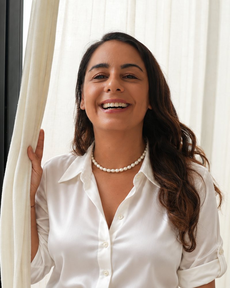 Cassandra Michael laughing beside a sheer curtain in her Bali home